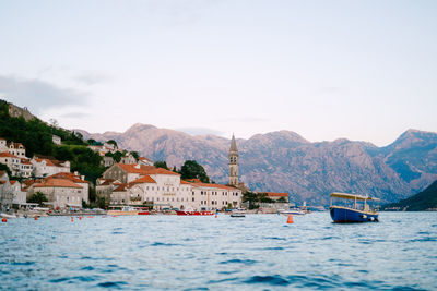 Scenic view of sea and buildings against sky