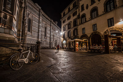 Empty road against buildings