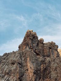 Low angle view of rock formation against sky