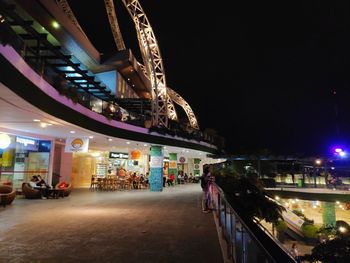 Illuminated bridge against sky in city at night