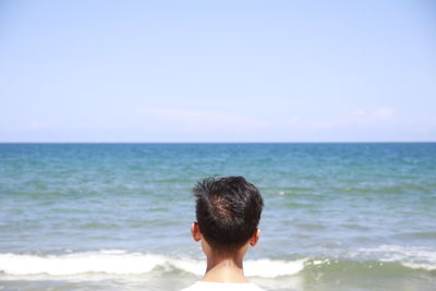 Rear view of woman looking at sea against sky