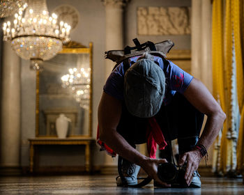 Rear view of man holding camera