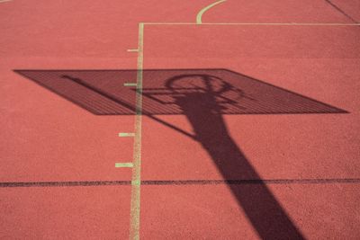 Shadow of basketball hoop on court