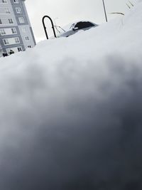 Low angle view of telephone on table against sky