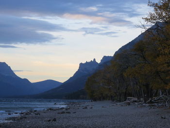 Scenic view of sea and mountains against sky during sunset