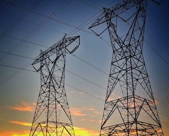 Low angle view of electricity pylon against sky