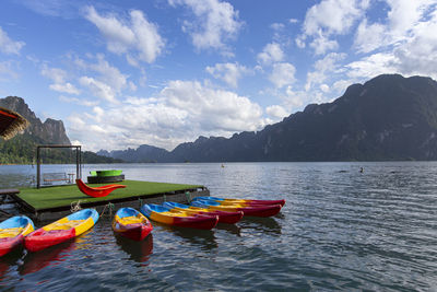 Boats moored in lake against sky