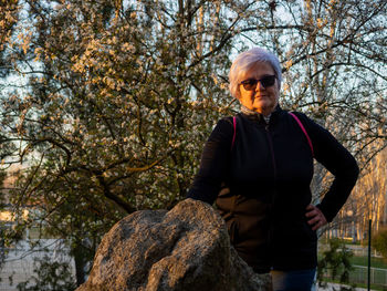 Portrait of man standing by tree