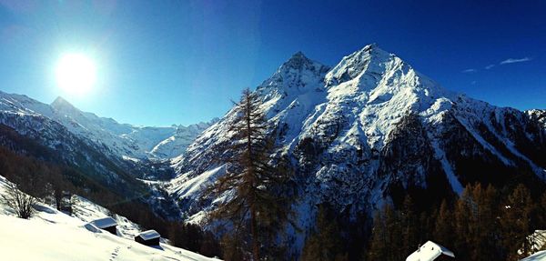 Scenic view of snow covered mountains against sky