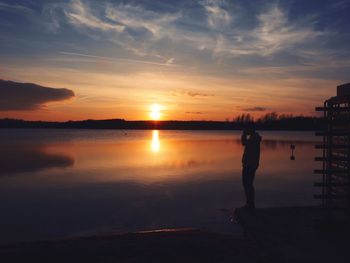 Scenic view of lake at sunset