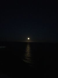 Scenic view of sea against clear sky at night