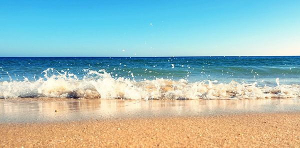 Scenic view of sea against clear blue sky