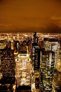 Aerial view of city lit up at night