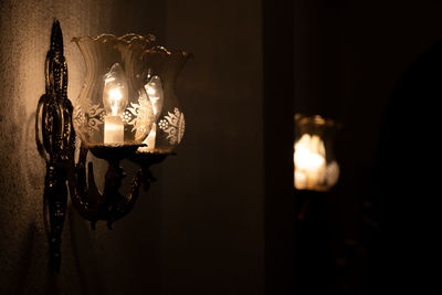 Close-up of illuminated lamp at night