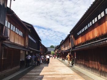 People on street against sky