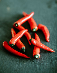Close-up of red chili peppers on table