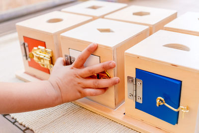 Cropped hands of person holding toy blocks