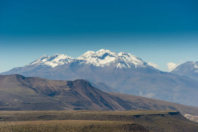 Scenic view of mountains against clear blue sky