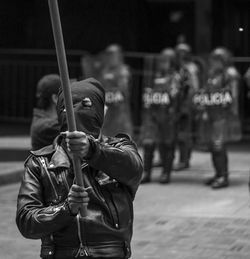 Protestor wearing mask while holding nightstick