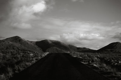 Road amidst mountains against sky