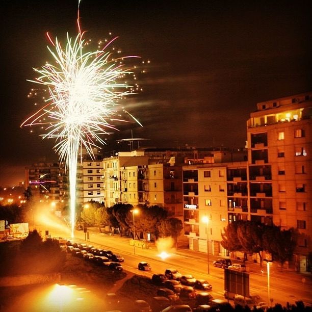 FIREWORK DISPLAY OVER CITY AT NIGHT