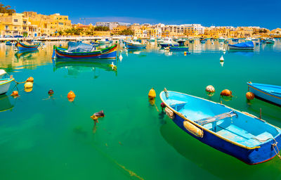 Boats moored at harbor