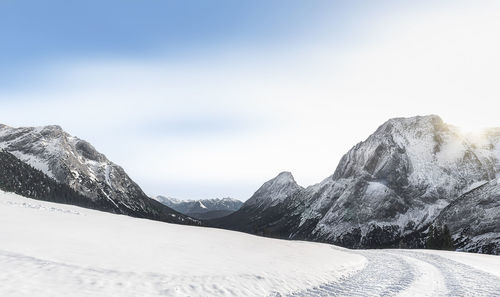 Scenic view of snowcapped mountains against sky