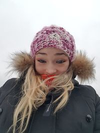 Portrait of young woman in hat during winter