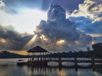 Scenic view of river against cloudy sky at sunset