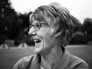 Close-up of mid adult woman laughing