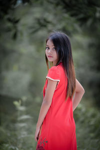 Portrait of young woman standing outdoors