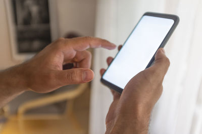 Midsection of man using mobile phone