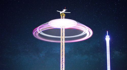 Low angle view of illuminated lights at night