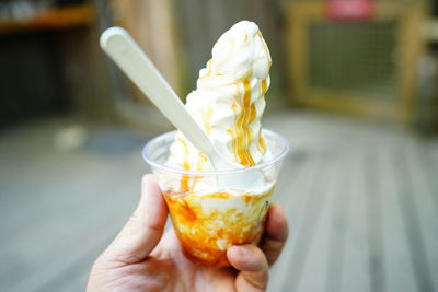 Close-up of hand holding ice cream