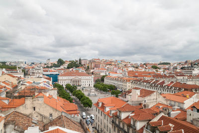 View of cityscape against cloudy sky