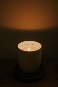 Close-up of illuminated tea light candles on table