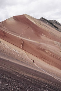 Amazing colorful rocky mountain and tourist hiking on curving road in bright day