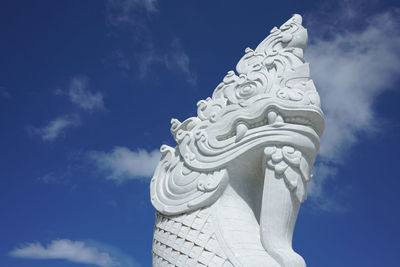 Low angle view of statue against blue sky