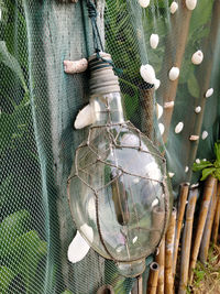 High angle view of decoration hanging on fence