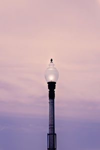 Low angle view of illuminated street light against sky at sunset