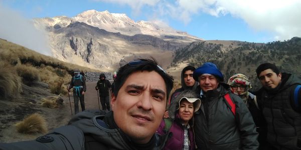 Portrait of people on mountains against sky