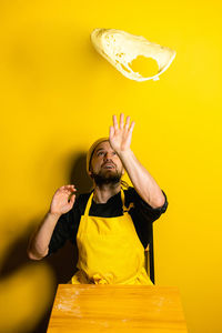 Chef preparing food against colored background