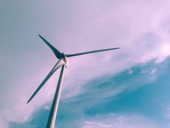 Low angle view of windmill against cloudy sky