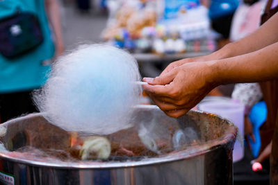 Close-up of hand holding ice cream at market