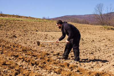 Full length of man working on field