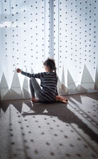 Rear view of girl sitting by decoration