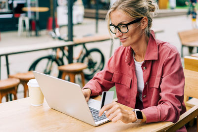 Young woman using laptop at table