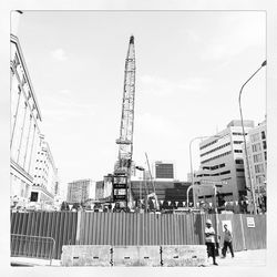 Construction site with cranes in background