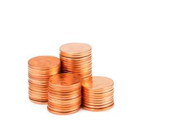 Close-up of coin stack against white background