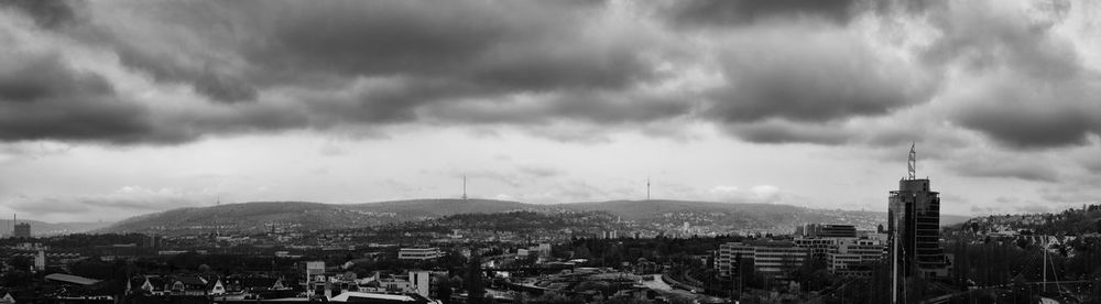 Cityscape against cloudy sky